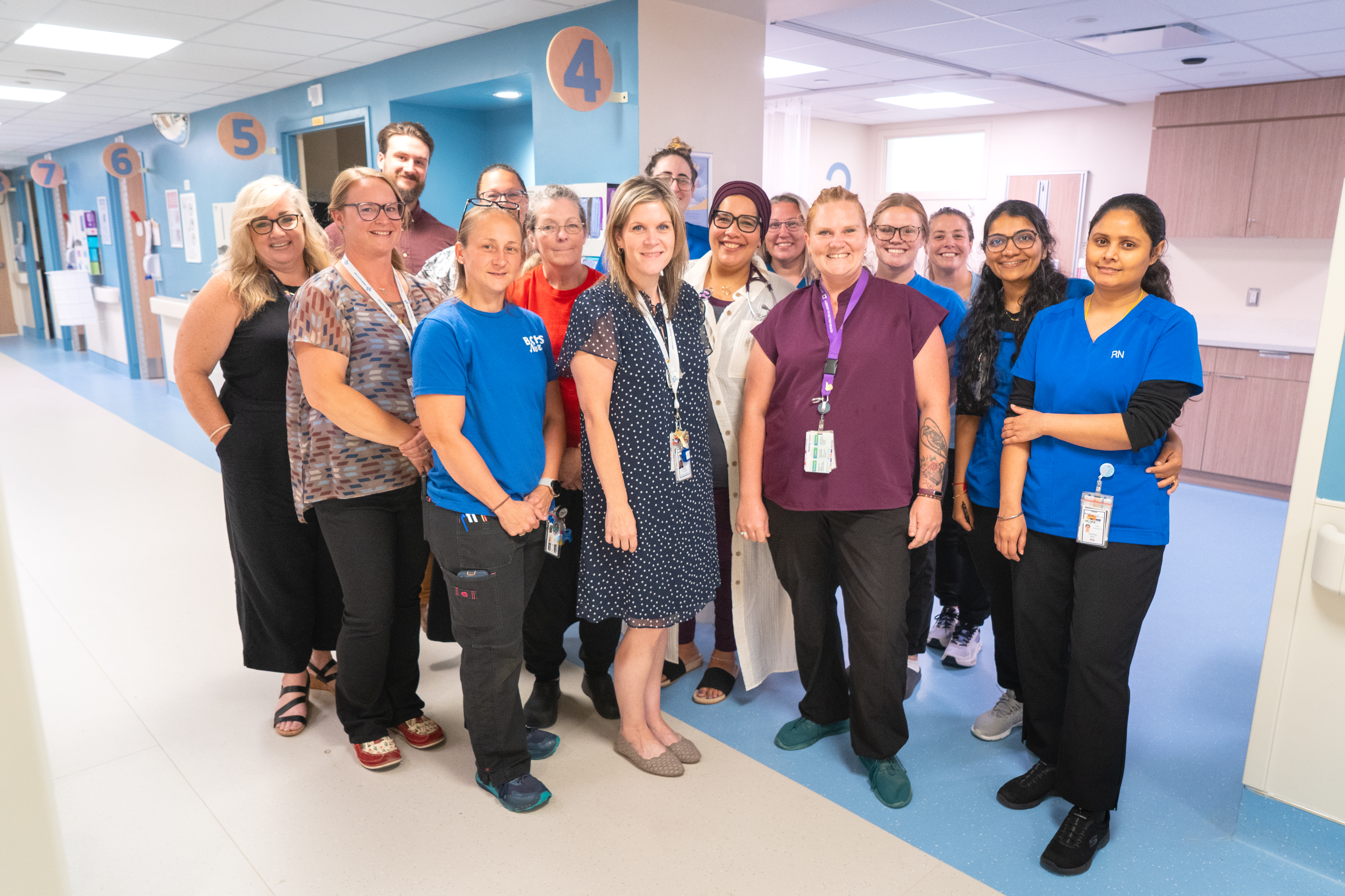 Kari Wilson (left), Dan DeJonge (back left), and Dr. Somaiah Ahmed (center middle), celebrate the opening of the new Andersen Ambulatory Assessment Area – Zone 7 with Emergency Department care teams and staff.