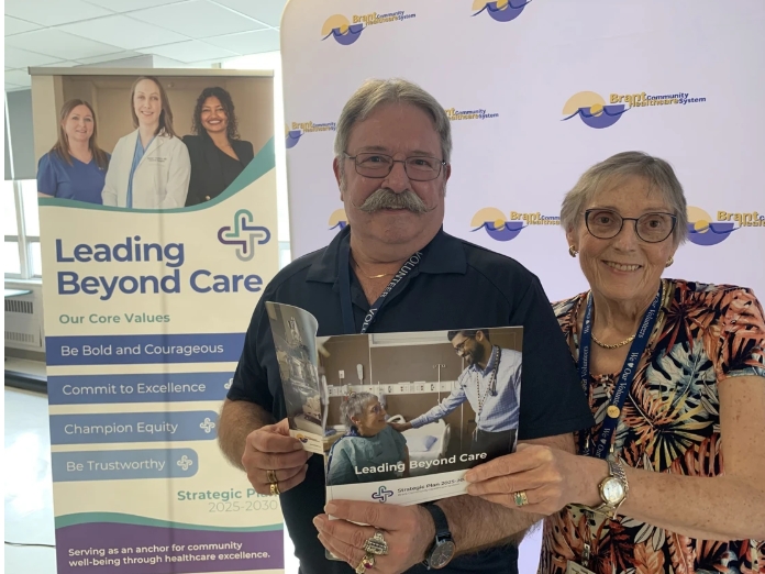 Harold Stahl and Anna Maynard with a copy of Leading Beyond Care, the Brant Community Healthcare System's new five-year strategic plan. which was announced Thursday.